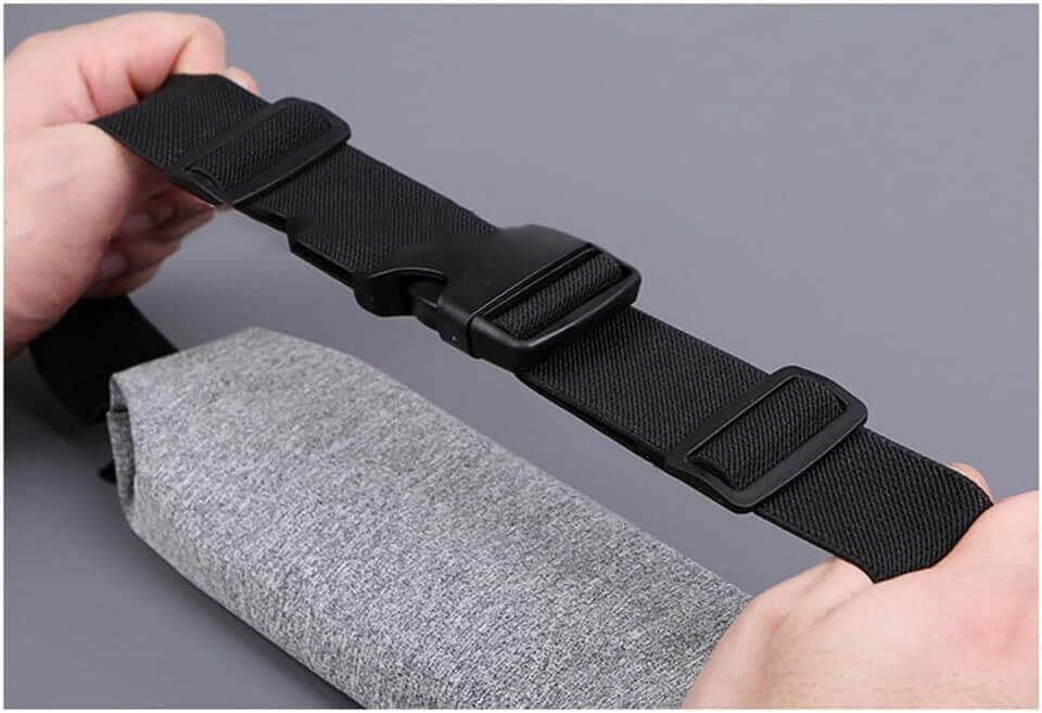 Hands adjusting the strap of the LumiPuro SileäVoima fitness equipment for optimal use.