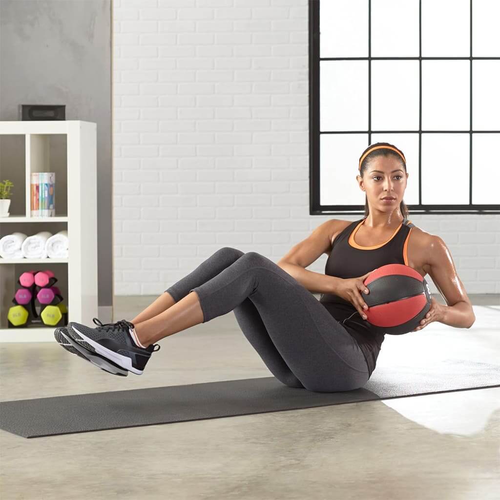 LumiPuro CoreBall in use during functional full body workout at home gym setting.