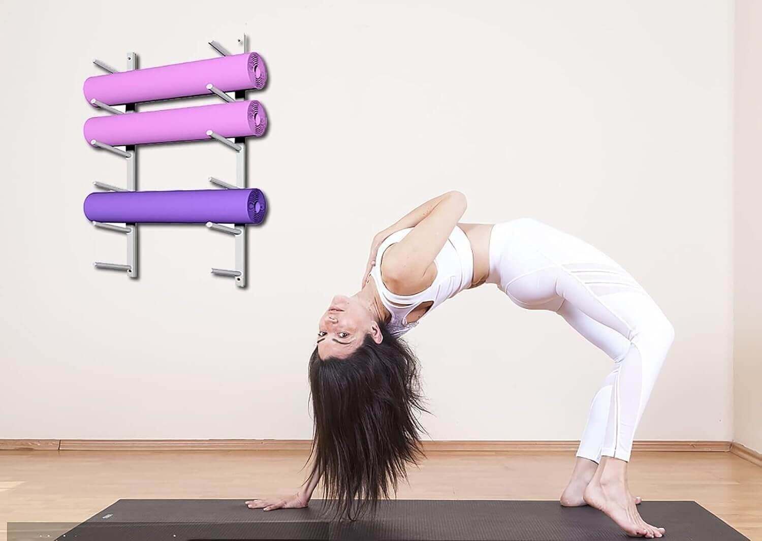 Woman practicing yoga in front of LumiPuro RullaSeinä storing foam rollers.